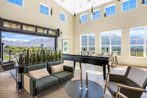 A living room with a pool table and a view of the mountains.