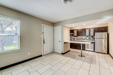 a kitchen with a sink and a refrigerator and a door