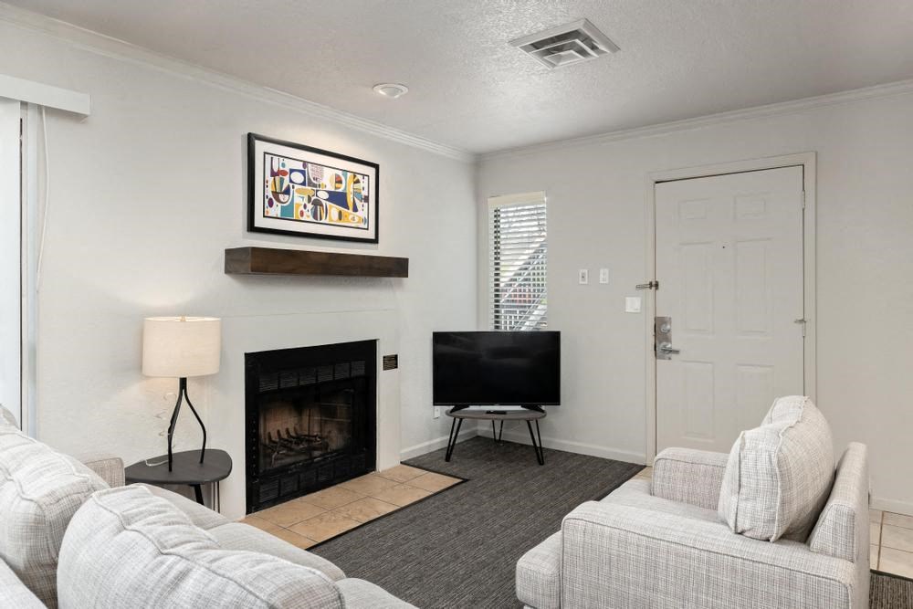 a living room with a fireplace and a television