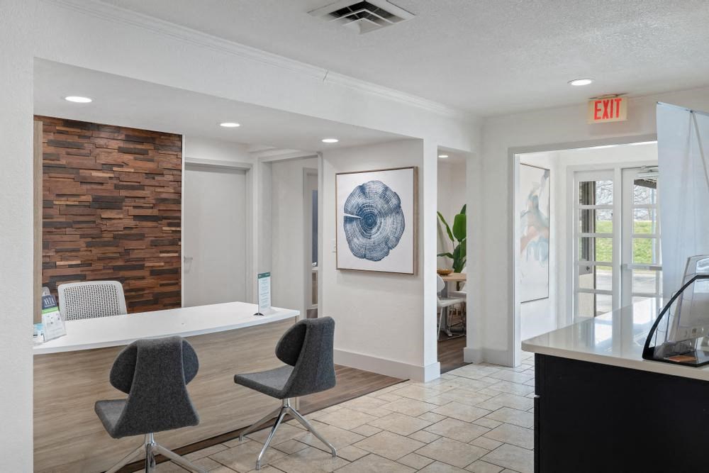 a room with a table and chairs and a painting on the wall
