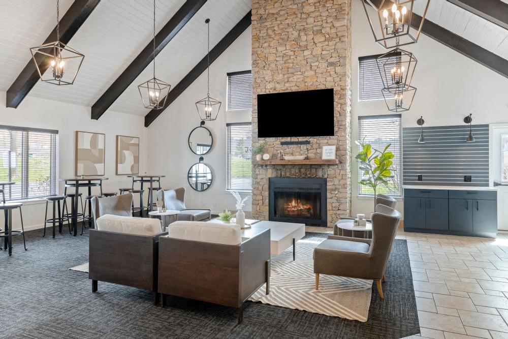 a living room with couches chairs and a fireplace