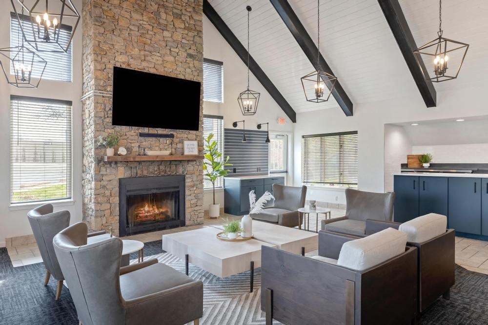 a living room with couches a coffee table and a fireplace