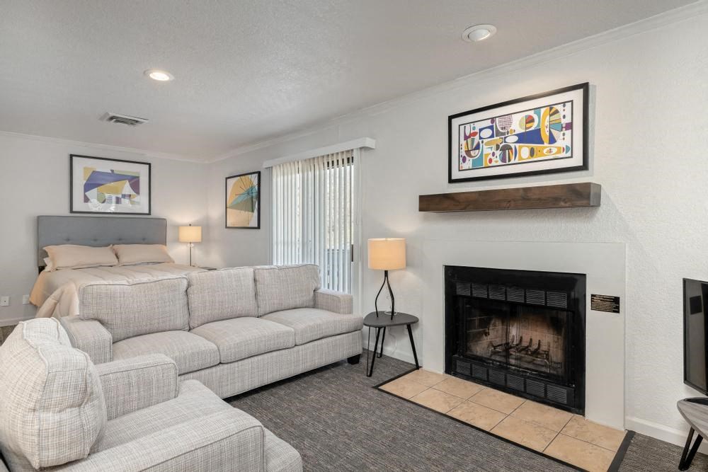 a living room filled with furniture and a fire place