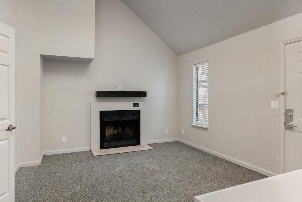 a living room with a fireplace and a door
