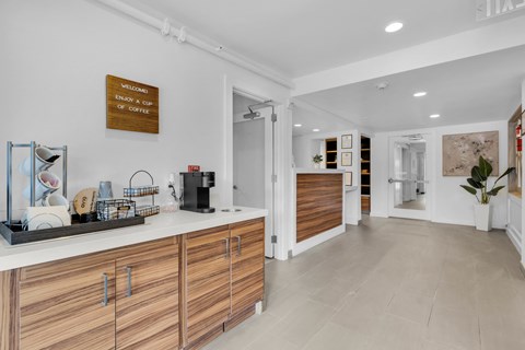 a kitchen with white walls and wooden cabinets and a white counter top at AVIA Lofts on Liberty Ridge Apartments, Florida, 32256