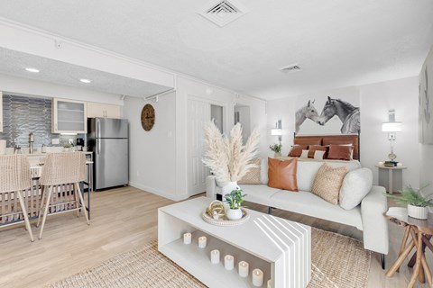 a living room with a couch and a table at AVIA Lofts on Liberty Ridge, Florida, 32256