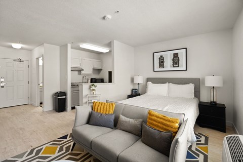 a living room with a couch and a bed