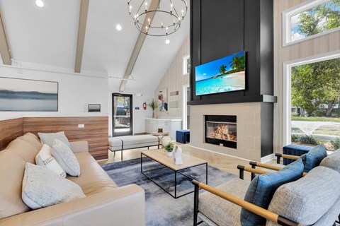 a living room with a couch and a fireplace at AVIA Lofts on Liberty Ridge Apartments, Florida
