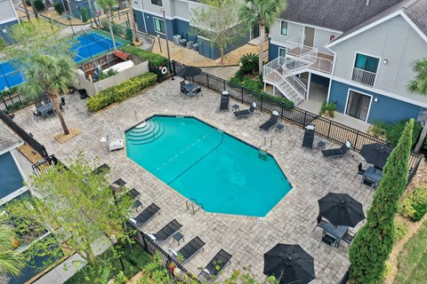 an aerial view of a swimming pool with umbrellas at AVIA Lofts on Liberty Ridge Apartments, Jacksonville, Florida