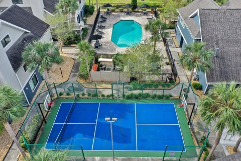 an aerial view of a tennis court and a pool in a house at AVIA Lofts on Liberty Ridge Apartments, Jacksonville, FL