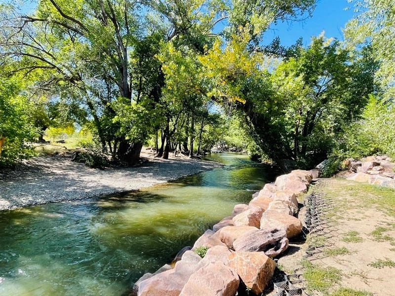 a river running next to a stone wall at The View on 20th, Ogden, Utah
