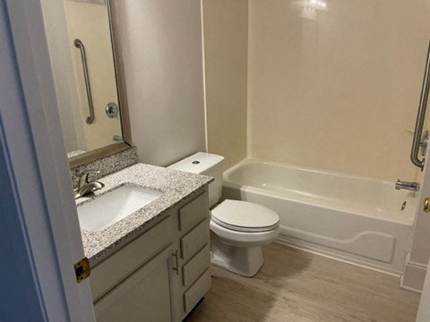 a bathroom with a sink toilet and a bath tub