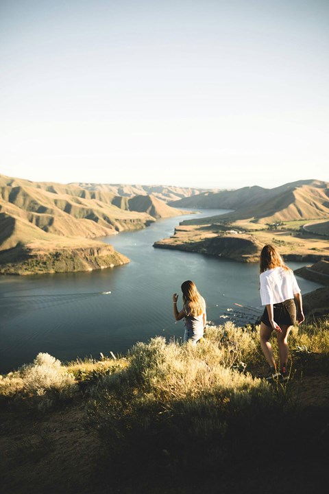 Two people are standing on a hill overlooking a river.at Alante Homes at Spring Run, Caldwell, ID
