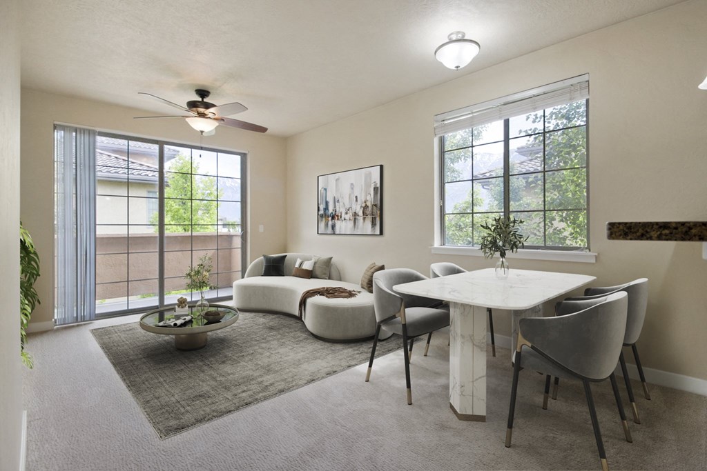 a living room with a couch a table and a ceiling fan at Siena Villas Apartments, Orem, 84097