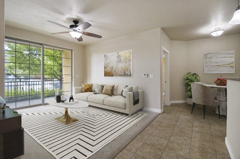 a living room with a couch and a ceiling fan