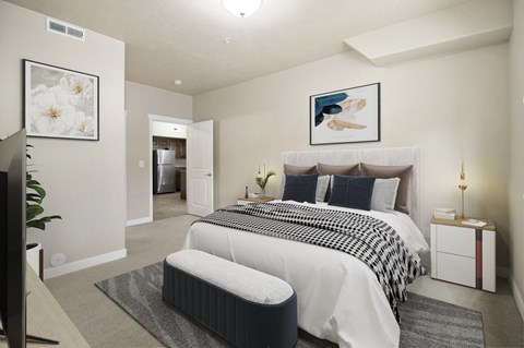 a bedroom with a bed and a chair in a room at Siena Villas Apartments, Orem, UT