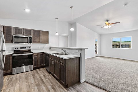 A kitchen with a stove top oven and a microwave above it.