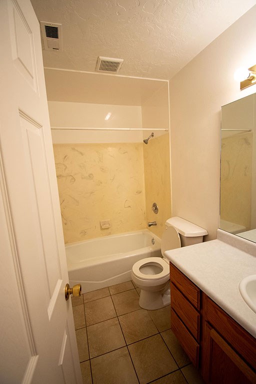 a bathroom with a toilet and a tub and a sink