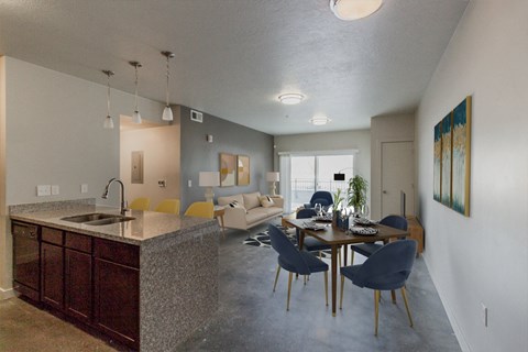 A kitchen with a dining table and chairs.