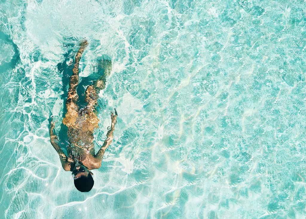 A man swimming in a pool. A man swimming in a pool.at Alante Homes at Spring Run, Caldwell