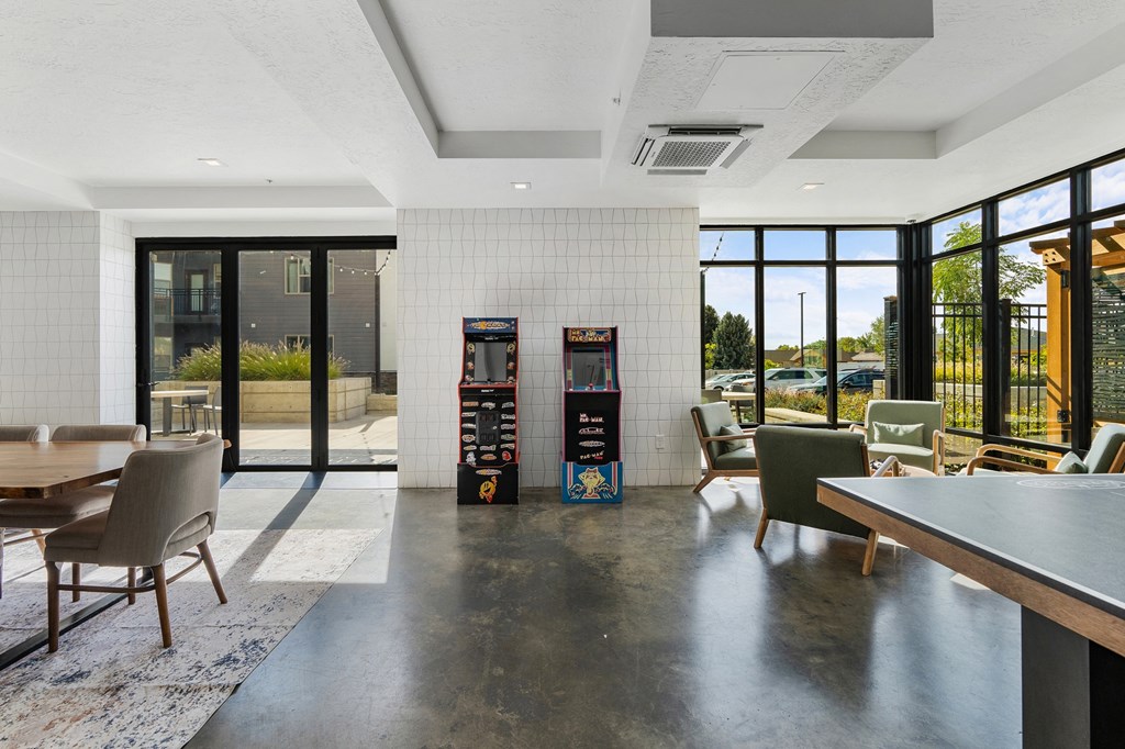 a lounge area with chairs and tables and vending machines at The Flats at Riverwoods, Provo, 84604