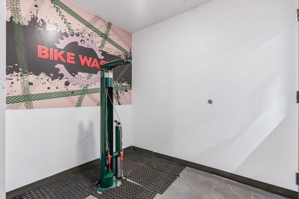 a green bike stand in the corner of a room at The Flats at Riverwoods, Provo, Utah