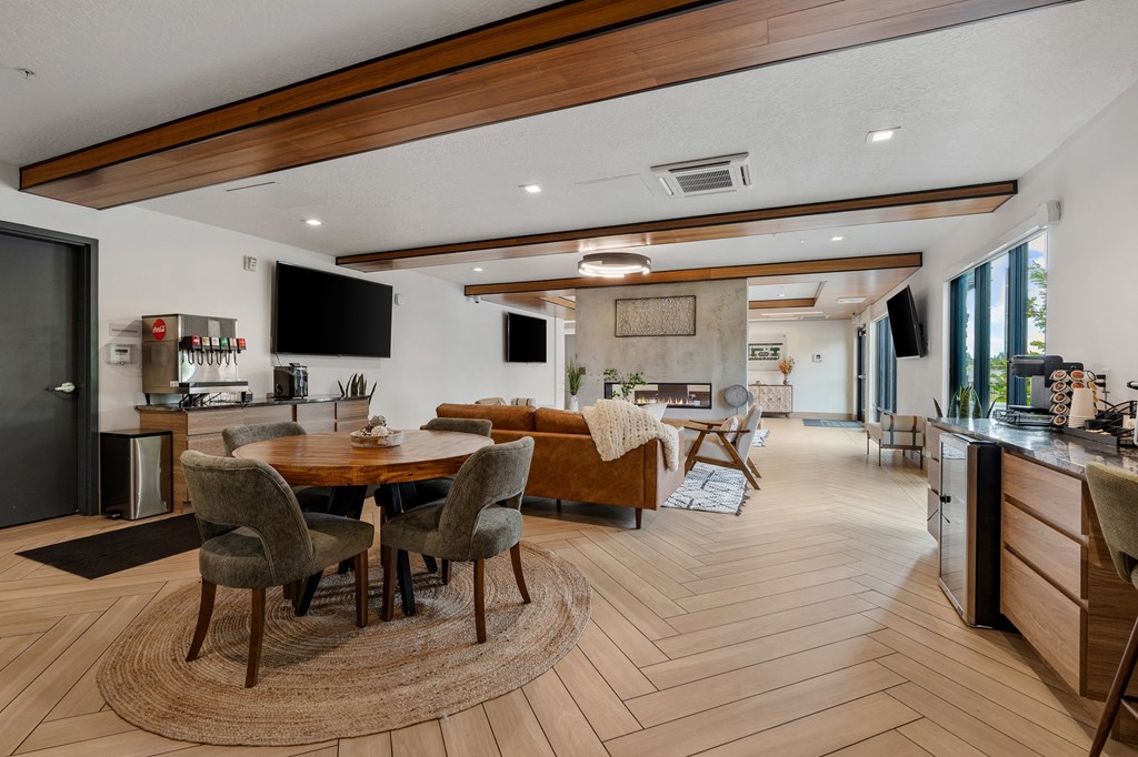 a living room and dining room with a table and chairs at The Flats at Riverwoods, Provo