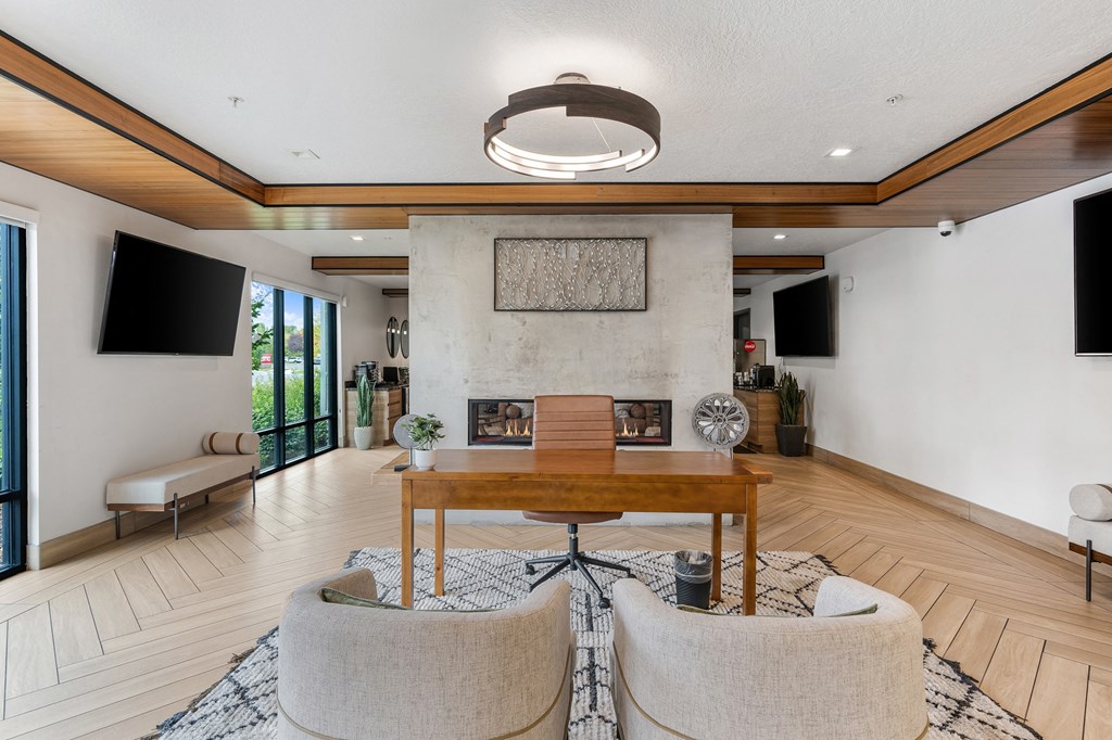 a living room with a fireplace and a table and chairs at The Flats at Riverwoods, Provo, 84604