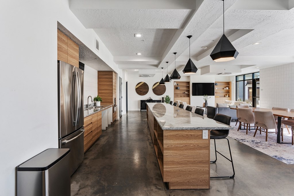 a large kitchen with a large island and a dining room at The Flats at Riverwoods, Provo, UT, 84604