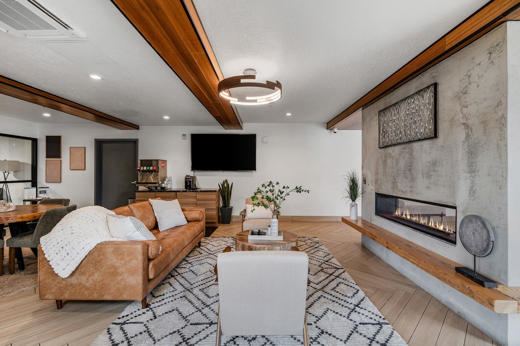 a living room with a couch and a fireplace at The Flats at Riverwoods, Provo, UT, 84604