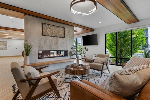 a living room with couches and chairs and a fireplace
