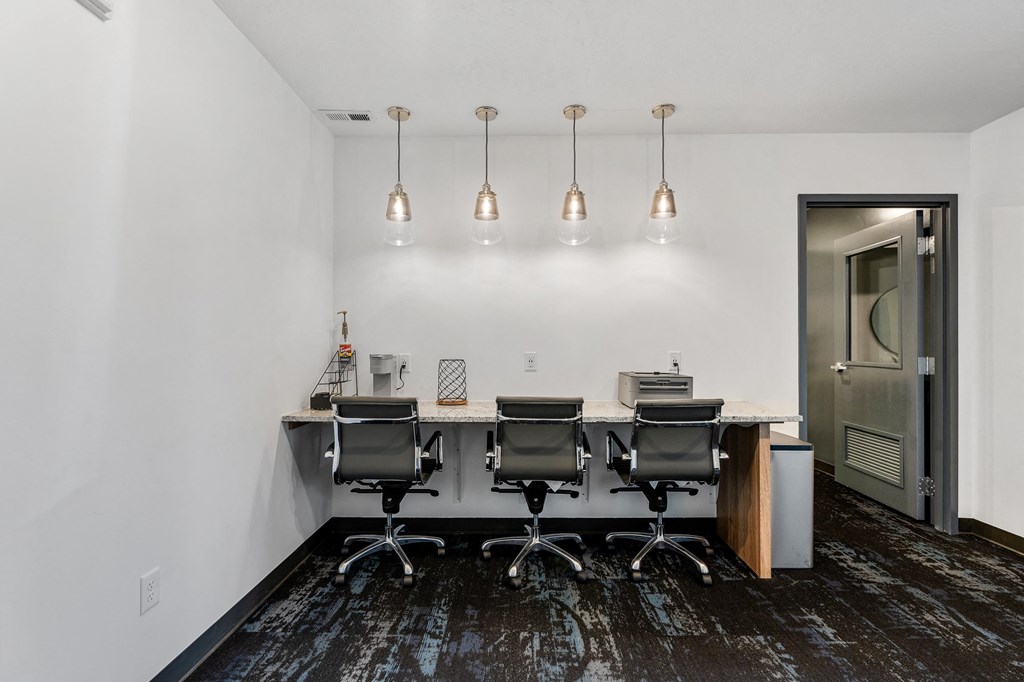 a conference room with a desk and chairs and a door at The Flats at Riverwoods, Provo, UT, 84604