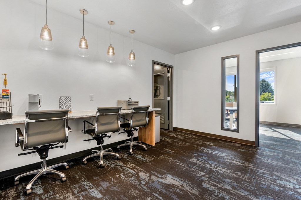 a conference room with a long desk and chairs and a window at The Flats at Riverwoods, Provo, Utah