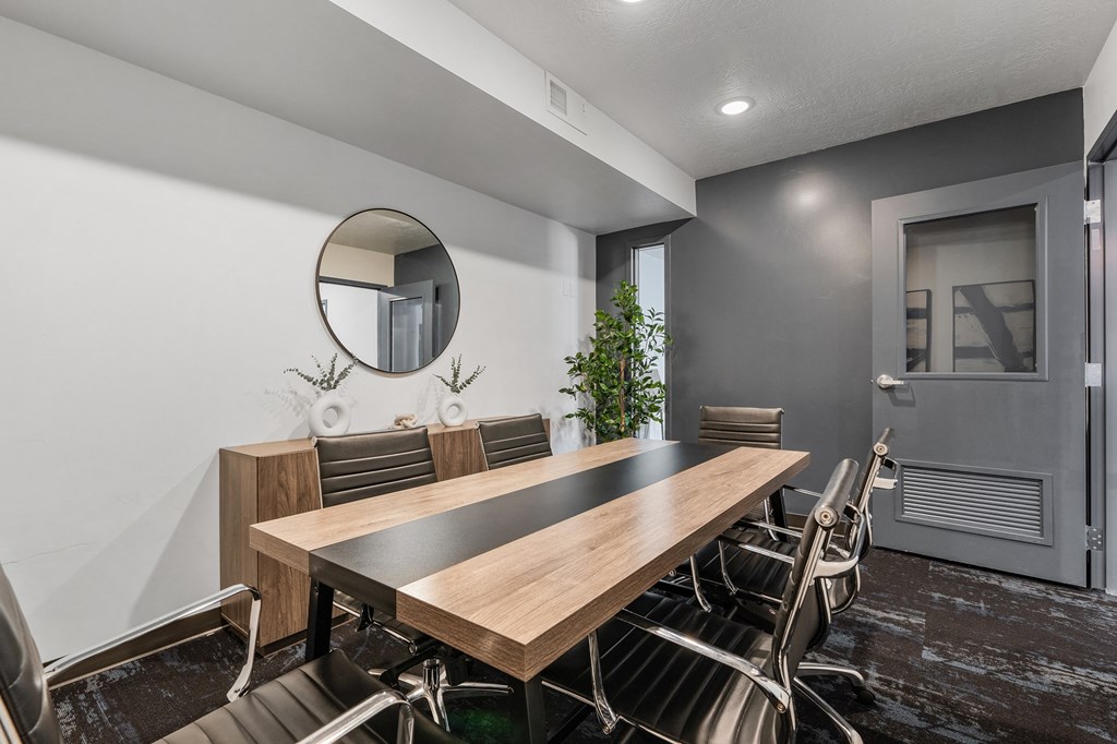 a conference room with a long wooden table and chairs at The Flats at Riverwoods, Provo, Utah