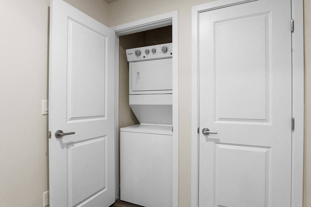 a pantry with white doors and a white stove and dishwasher at The Flats at Riverwoods, Provo, UT, 84604