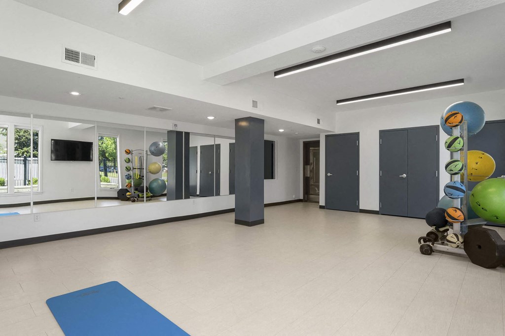 a large multipurpose room with white walls and a beige tile floor at The Flats at Riverwoods, Provo, UT