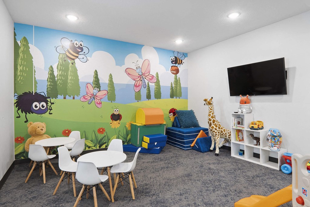 a room with a mural on the wall and a table and chairs in front of it at The Flats at Riverwoods, Provo