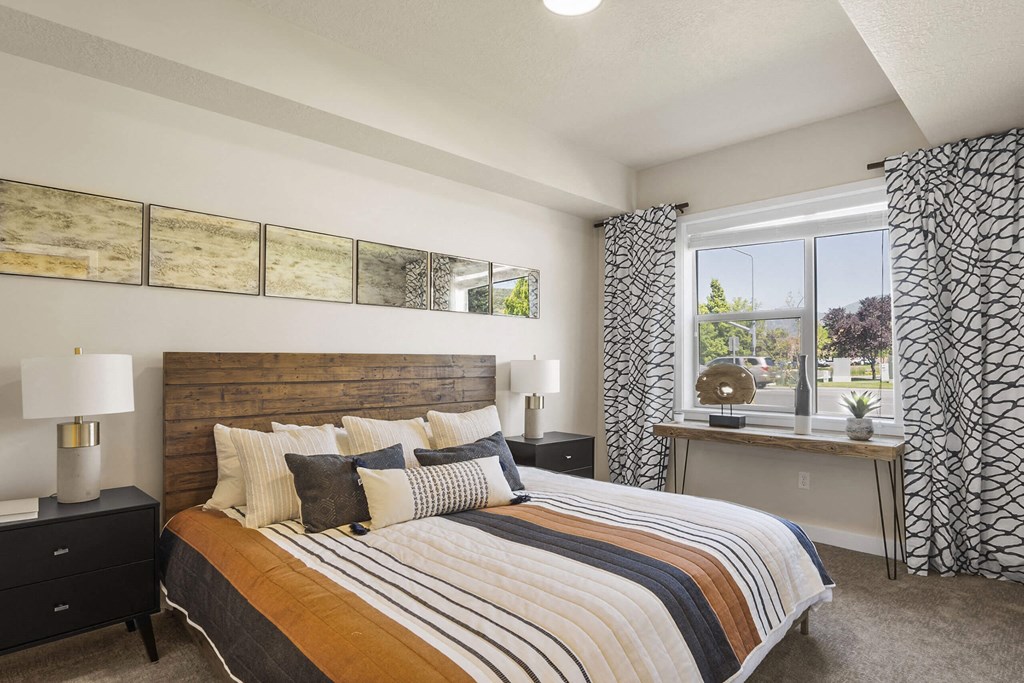 a bedroom with a large bed and a window