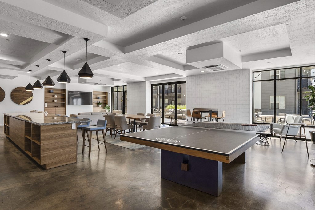 a communal area with a ping pong table at The Flats at Riverwoods, Provo, Utah