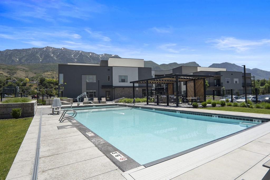 a pool with mountains in the background at The Flats at Riverwoods, Provo, 84604