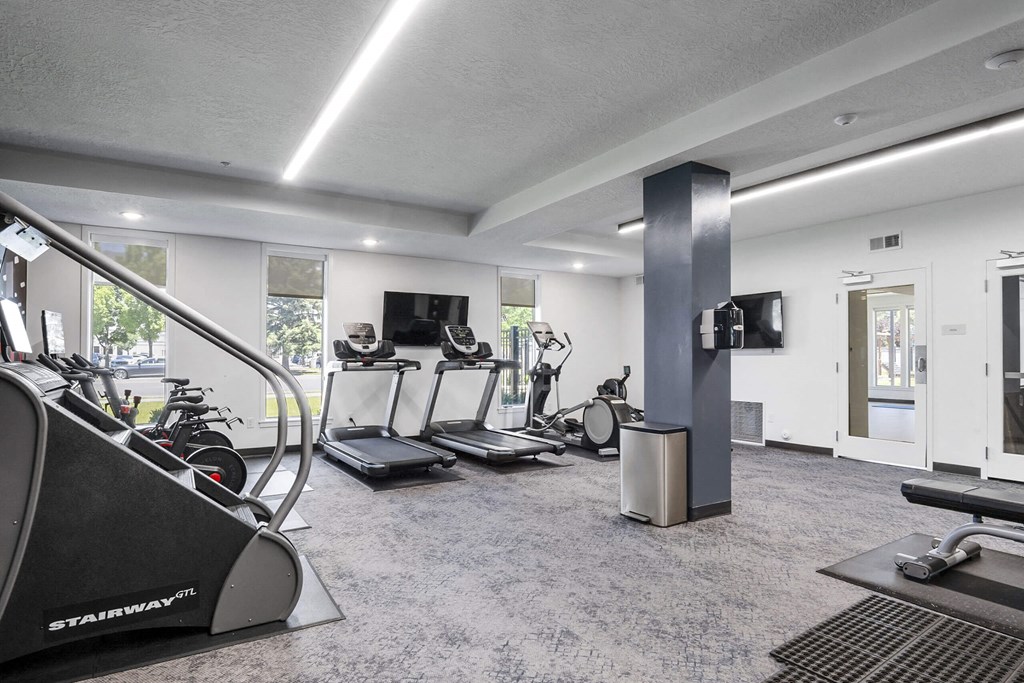 a gym with treadmills and other exercise equipment at The Flats at Riverwoods, Provo, UT