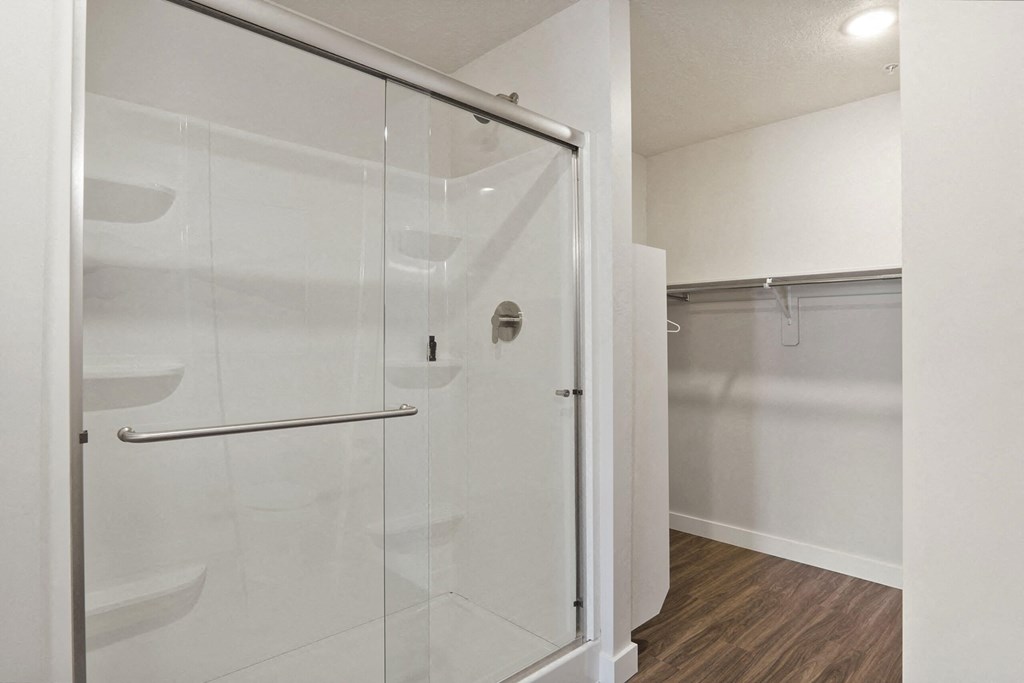 a bathroom with a glass shower stall in a 555 waverly unit at The Flats at Riverwoods, Provo, UT