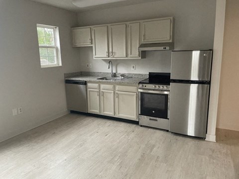 a kitchen with stainless steel appliances and white cabinets