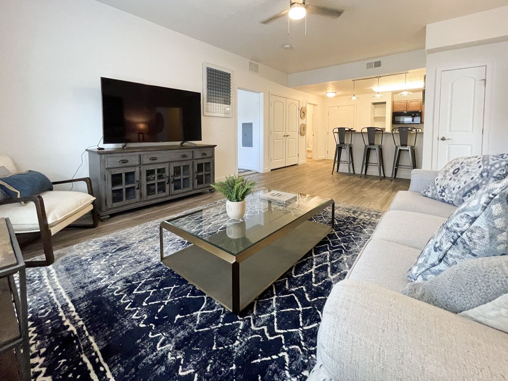 a living room with a couch a coffee table and a tv at The View on 20th, Ogden, UT, 84401