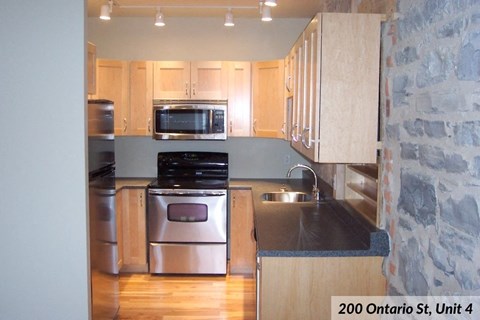 a kitchen with stainless steel appliances and wooden cabinets