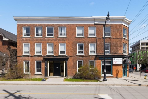 A red brick building with a black awning and a sign that says "Blackberry".