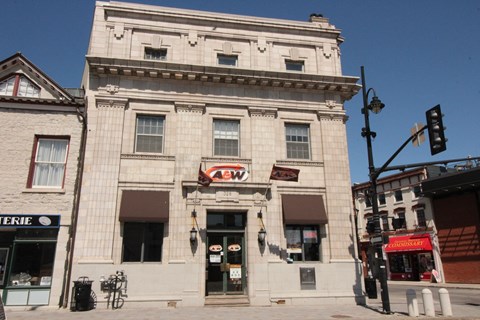 a large white building on the corner of a city street