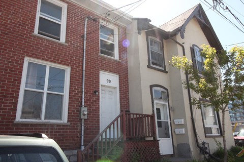 the front of a brick house with a white door