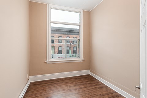 A room with a window showing a view of a building with the word "Champion" on it.