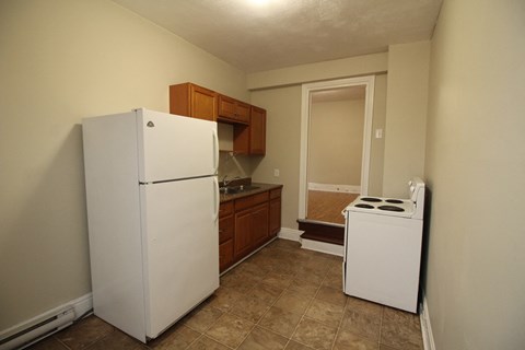 a kitchen with a refrigerator and a stove in it